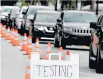  ?? SUSAN STOCKER/SOUTH FLORIDA SUN SENTINEL ?? Drivers wait in line for COVID-19 testing Tuesday at Holiday Park in Fort Lauderdale. Over the past seven days, the state has reported an average of 126 deaths per day.