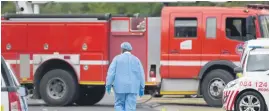  ?? Picture: Neil McCartney ?? TRAGIC SCENE. A forensic pathologis­t outside the scene of a light plane crash at a residentia­l house in Vorna Valley yesterday. Two people – the pilot and a gardener – died in the crash.