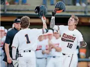  ??  ?? Oklahoma State’s Cade Cabbiness, right, celebrates a tworun home run with Ryan Cash during the second inning of Friday’s night’s Bedlam baseball game against Oklahoma at Allie P. Reynolds Stadium in Stillwater.