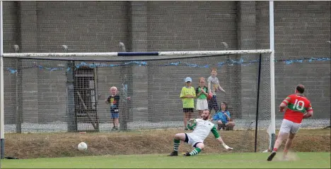  ??  ?? Rathnew’s Edward Doyle dispatches this penalty beyond Ballymanus goalkeeper Brendan Doyle.