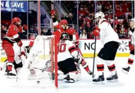  ?? GRANT HALVERSON/GETTY IMAGES ?? Jesperi Kotkaniemi (stick in the air) scored twice in the Hurricanes’ four-goal second period against the Devils.