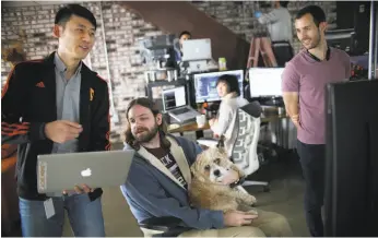  ?? Sandy Huffaker / Special to The Chronicle 2017 ?? Kan Wang (left), an H-1B visa holder and engineer at data-collection firm Zeeto, works on a project with Her Johnson at their offices in San Diego in 2017.