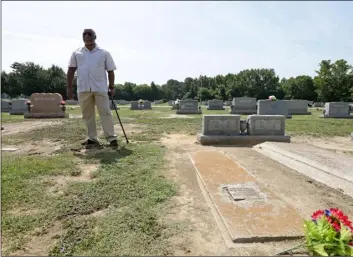  ??  ?? In this Wednesday, July 11, photo, Larry Monk standing where his father was buried beside his mother’s grave at Elmwood Cemetery in Goldsboro, N.C. AP Photo/Gerry brooMe