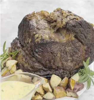  ?? MATTHEW MEAD/ THE ASSOCIATED PRESS ?? Slow Roasted Standing Rib Roast With Béarnaise Sauce.