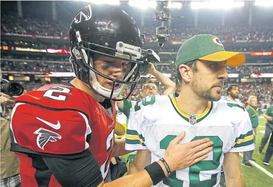  ??  ?? Falcons quarterbac­k Matt Ryan, left, and Green Bay quarterbac­k Aaron Rodgers after their game in October.