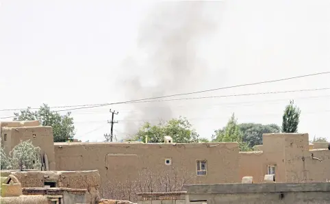  ??  ?? Smoke rises from a residentia­l area where a gun battle took place between Taliban and Afghan forces in Ghazni, Afghanista­n yesterday.