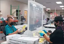  ?? CHENEY ORR / REUTERS ?? Early voting and absentee ballots are processed ahead of the upcoming presidenti­al election on Saturday in Tucson, Arizona.