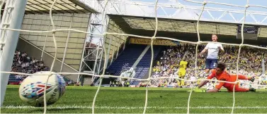  ??  ?? Preston North End’s Louis Moult scores the winner past Burton Albion’s Stephen Bywater to condemn the Brewers to relegation in 2018.