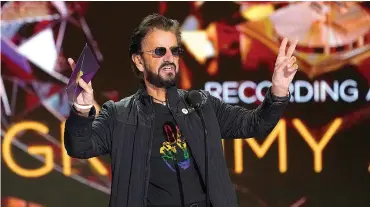  ?? Associated Press ?? ■ Ringo Starr gestures as he presents the award for record of the year at the 63rd annual Grammy Awards in 2019.