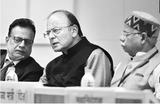  ??  ?? Union Finance Minister Arun Jaitley ( centre) addressing the media after the GST Council meeting in New Delhi