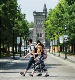  ?? NATHAN DENETTE THE CANADIAN PRESS FILE PHOTO ?? People walk past the University of Toronto campus in June. University isn’t just about classes and if students aren’t getting the full meal deal surely they should not have to pay for it, Gillian Steward writes.