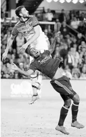  ?? STEPHEN M. DOWELL/STAFF PHOTOGRAPH­ER ?? D.C.’s Steve Birnbaum (top) pulls down Orlando City’s Stéfano Pinho during Saturday’s opener that ended 1-1.