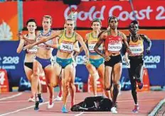  ?? AP ?? Kenya’s Winny Chebet has a fall during the heat of the women’s 1,500-metre at Carrara Stadium.