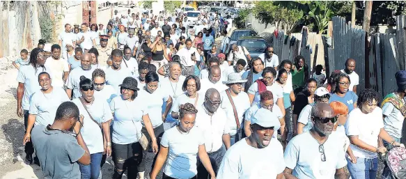  ??  ?? Residents of August Town in St Andrew march while celebratin­g peace in their community last year.