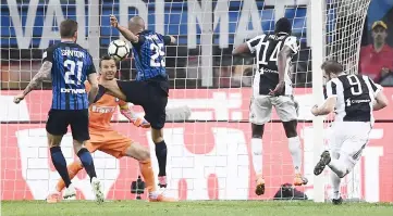  ??  ?? Gonzalo Higuain (right) scores a goal during the Italian Serie A football match between Inter Milan and Juventus at the San Siro Stadium in Milan in this April 28 file photo. — AFP photo