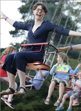  ??  ?? Helen and Maeve Cotinat on the vintage chair-o-planes.