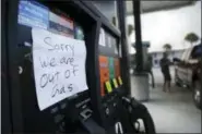  ?? DAVID GOLDMAN — THE ASSOCIATED PRESS ?? A note is posted to a gas pump after the station ran out of gas ahead of Hurricane Irma in Daytona Beach, Fla., Friday. Coastal residents around South Florida have been ordered to evacuate as the killer storm closes in on the peninsula for what could...