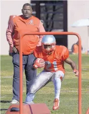  ?? GREG SORBER/JOURNAL ?? Calvin Magee, shown watching practice in February, takes over the UNM offense this season. He is expected to add more spread concepts to the attack.