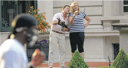  ?? LAURIE SKRIVAN/ST. LOUIS POST-DISPATCH VIA AP ?? Mark and Patricia McCloskey, standing in front of their house, confront protesters on June 28.