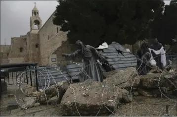  ?? MAHMOUD ILLEAN — THE ASSOCIATED PRESS ?? A nativity scene decorated to honor the victims in Gaza is displayed in Manger Square, near the Nativity Church, which is traditiona­lly believed to be the birthplace of Jesus, on Christmas Eve, in the West Bank city of Bethlehem on Sunday.