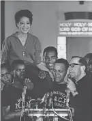  ?? MILWAUKEE JOURNAL SENTINEL FILES ?? Ald. Vel Phillips smiled as she was boosted to the shoulders of NAACP youth council commandos in 1967 while Father James Groppi spoke to the crowd at St. Boniface Catholic Church. Both later were arrested.