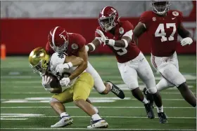  ?? RON JENKINS — THE ASSOCIATED PRESS ?? Notre Dame running back Chris Tyree (25) is stopped by Alabama defensive back Patrick Surtain II (2) with help from defensive back Jordan Battle (9) and defensive lineman Byron Young (47) during the game in Arlington, Texas, Friday.