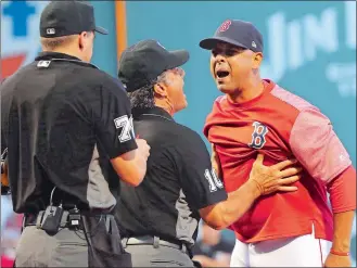  ?? ELISE AMENDOLA/AP PHOTO ?? Boston Red Sox manager Alex Cora is held back by first base umpire Phil Cuzzi (10) as Cora argues with home plate umpire Adam Hamari after both Red Sox and New York Yankees pitchers were warned against hitting batters in the first inning of Friday’s game. Cora was ejected.