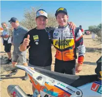  ?? ?? Alfie Cox (13 time Dakar Rally finisher) with his son, Bradley Cox at Bradley’s first Dakar Rally finish in Saudi Arabia. Image supplied.