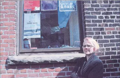  ?? NIKKI SULLIVAN/CAPE BRETON POST ?? Ali MacDougall, box office director for the Highland Arts Theatre in Sydney, stands beside the window vandals smashed with a rock on Tuesday afternoon.