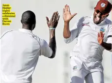  ??  ?? Jason Holder (right) celebrates a dismissal with Darren Bravo