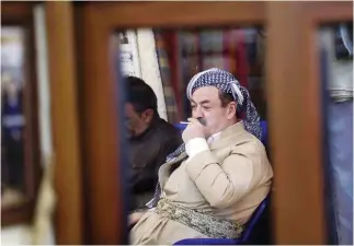  ??  ?? An Iraqi Kurdish man smokes in a cafe in Irbil, the capital of the autonomous Kurdish region of northern Iraq. (AFP)