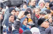  ?? SERGEI GAVRILENKO/ASSOCIATED PRESS ?? Igor Vostrikov, center, who lost his 3 daughters, wife and sister in the locked movie theater, is part of a crowd gathered to pay their respects in Kemerovo on Tuesday.