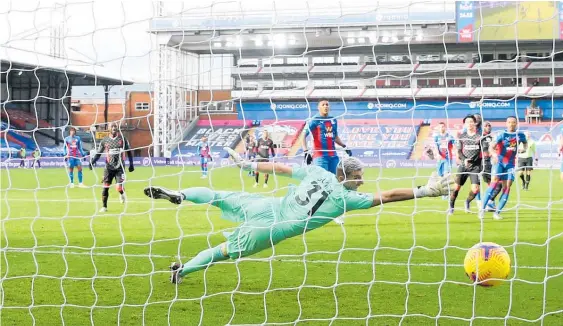  ?? Photo / Getty Images ?? Palace’s Vicente Guaita sees Sadio Mane score for Liverpool. Guaita was at risk of cricking his neck, looking back at his goal seven times.