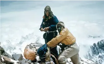  ??  ?? FROM LEFT
Sir Edmund Hillary and Tenzing Norgay on their climb to the top of Everest; A Rolex Oyster Perpetual watch worn on the Swiss expedition to the Gangotri mountain range in 1947