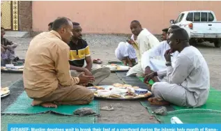  ?? ?? GEDAREF: Muslim devotees wait to break their fast at a courtyard during the Islamic holy month of Ramadan in Gedaref on March 12, 2024. — AFP