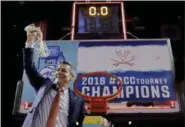  ?? JULIE JACOBSON — ASSOCIATED PRESS ?? Virginia head coach Tony Bennett holds up the net after his team defeated North Carolina in the championsh­ip game of the ACC tournament.