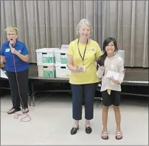  ?? Courtesy photo ?? Facilitato­r Joanne Laird congratula­tes 3rd grade student Audri Taamu for winning one of the McDonald’s gift cards for a correct answer in the Dictionary Treasure Hunt activity. Presenting Audri her gift card is Rotary member Senator Roz Baker.