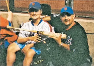  ?? Chris Sobel ?? CHERISHED SOUVENIR: Longtime Mets fan Chris Sobel and his son, Sean, show off an autographe­d bat given them by David Wright at a 2006 game in Arizona.