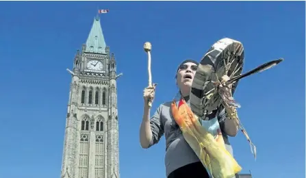  ?? ADRIAN WYLD/THE CANADIAN PRESS ?? Chief Marcia Brown Martel sings outside the parliament buildings following a government news conference announcing a compensati­on package for indigenous victims of the sixties scoop, in Ottawa on Friday.