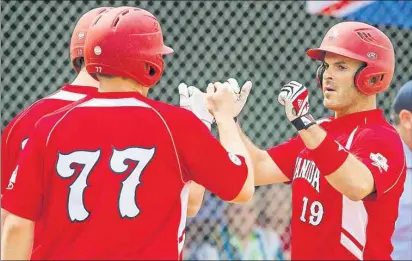  ?? SOFTBALL CANADA ?? St. Lawrence’s Jeff Ellsworth, right, won gold Sunday with Canada at the Internatio­nal Softball Federation world championsh­ip in Saskatoon.