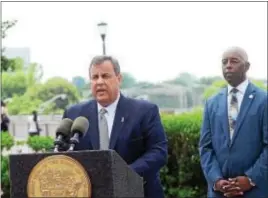  ?? GREGG SLABODA — THE TRENTONIAN ?? Gov. Chris Christie, left, announces further plans for the Trenton initiative at a press briefing on Wednesday. Looking on is Trenton Mayor Eric Jackson