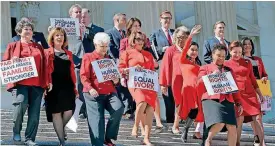  ??  ?? House Minority Leader Nancy Pelosi of California, center, and other Democratic Congressio­nal members, walk down the steps on Capitol Hill in Washington on Wednesday for an event to honor Internatio­nal Women’s Day.
