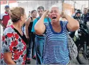  ?? Katherine Ortiz Getty Images ?? A RELATIVE of a prisoner cries at the police station on Wednesday after the deadly jail fire in Venezuela.