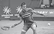  ?? [AP PHOTO] ?? Boran Coric returns the ball to Roger Federer during the final match at the Gerry Weber Open on Sunday in Halle, Germany.