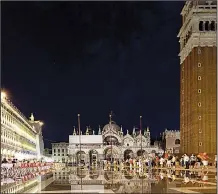  ?? Rick Steves’ Europe/DOMINIC ARIZONA BONUCCELLI ?? Nighttime on St. Mark’s Square comes with ambience-filled cafes, dueling orchestras, and sometimes some atmospheri­c flooding.