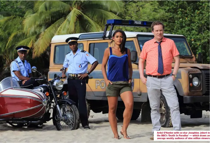 ??  ?? Ardal O’Hanlon with co-star Josephine Jobert in the BBC’s ‘Death In Paradise’ — which draws an average weekly audience of nine million viewers