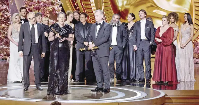 ?? - PHOTO BY TRAE PATTON/AMPAS ?? Producer Emma Thomas and director Christophe­r Nolan are joined by the cast of 'Oppenheime­r' in accepting the Best Picture prize.