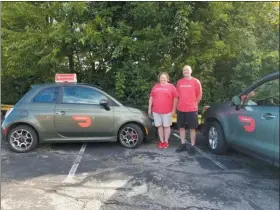  ?? JORDANA JOY — THE MORNING JOURNAL ?? Decals on the sides of their vehicles is one of the ways how DoorDash drivers Christine Mazurek, left, and Dave Revercomb are trying to improve the delivery company’s marketabil­ity. DoorDash has been steadily expanding in Northeast Ohio.