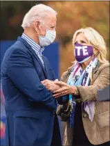  ?? Andrew Harnik / Associated Press ?? Joe Biden and his wife Jill arrive at a drive- in campaign stop at Bucks County Community College in Bristol, Pa., Saturday.