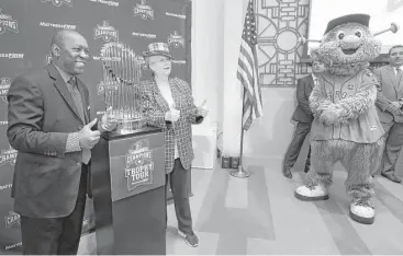  ?? Melissa Phillip / Houston Chronicle ?? Mayor Sylvester Turner, left, and political consultant Sue Davis pose with the Commission­er’s Trophy as the Astros begin a tour with the symbol of their first championsh­ip at City Hall on Monday. The trophy tour will make over 100 stops throughout...